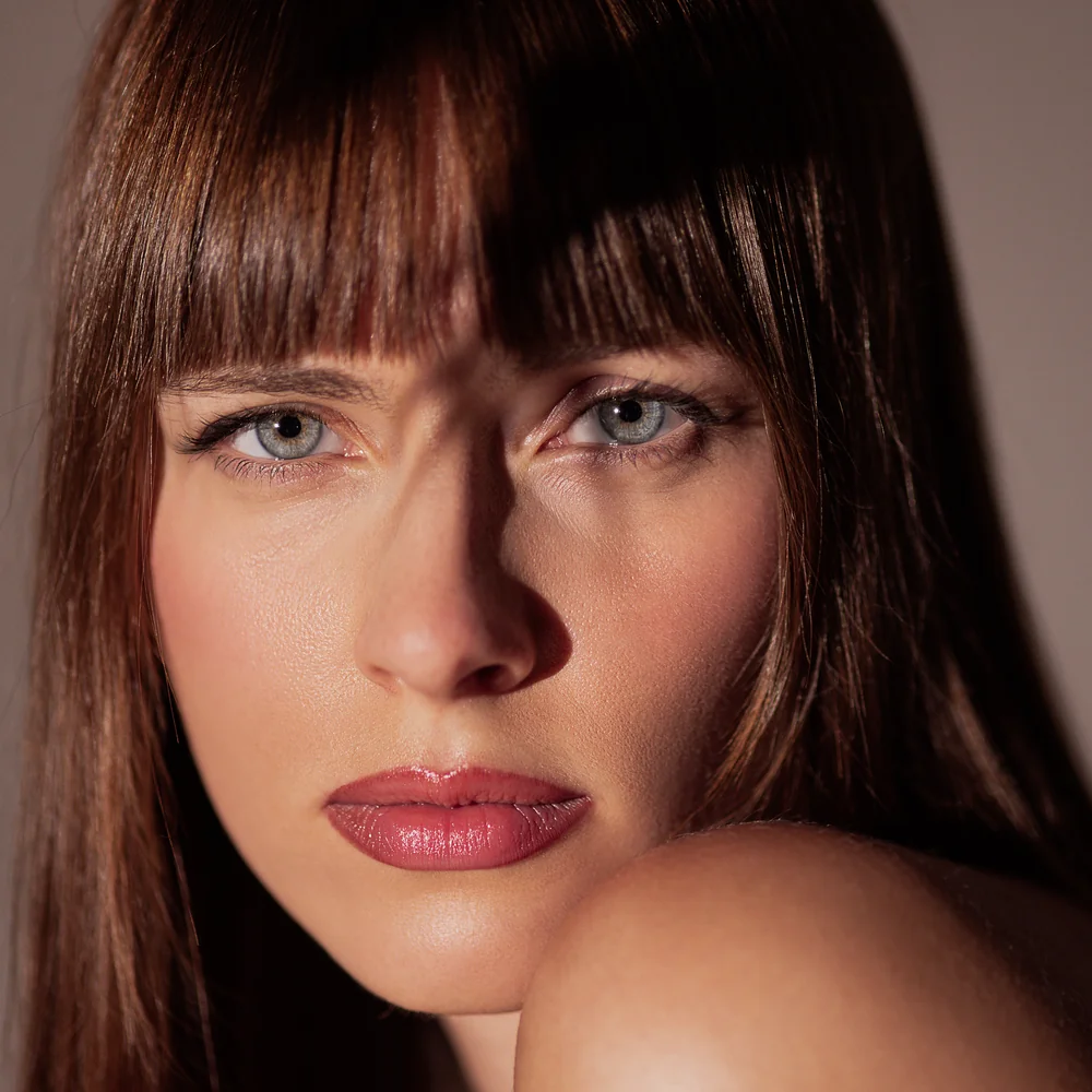 Retrato editorial de mujer con luz natural sobre el rostro
